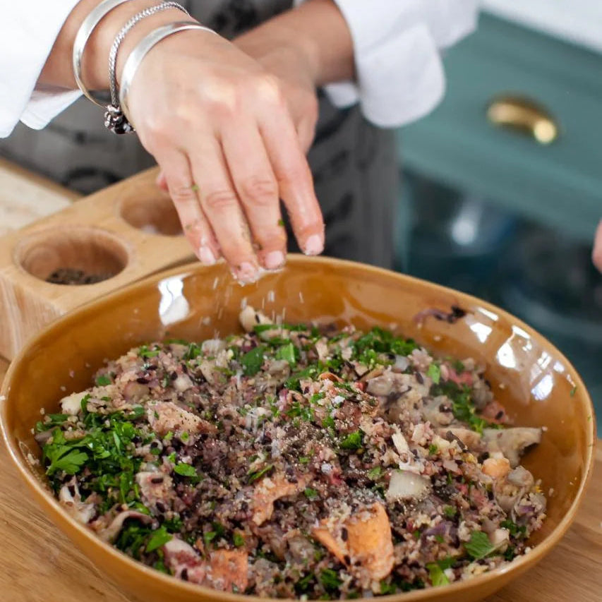 hand seasoning a salad